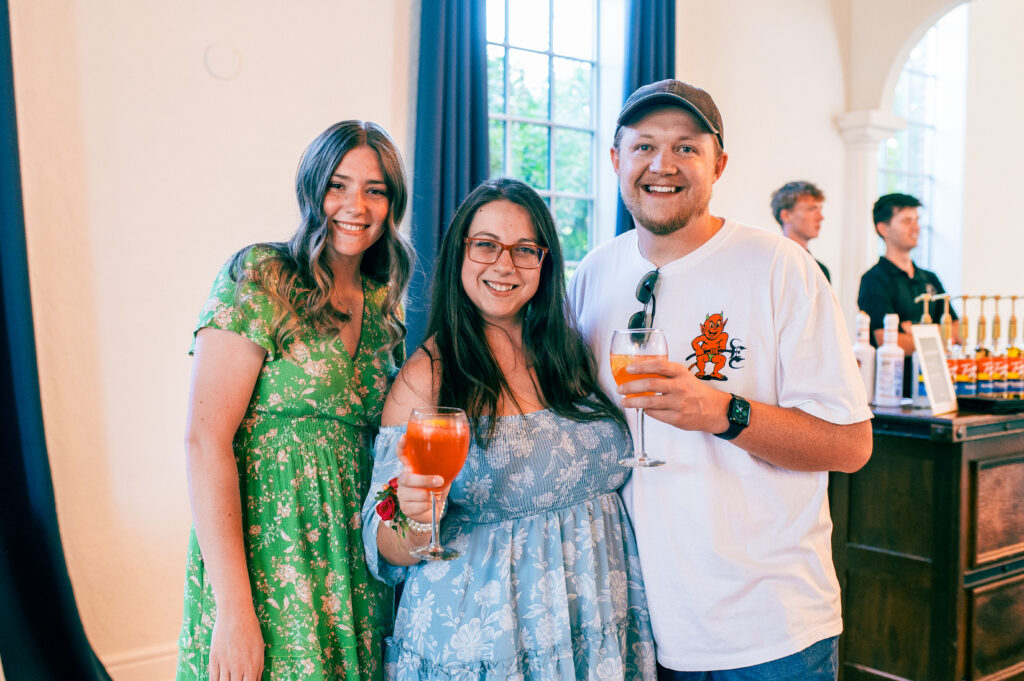 Vendors gathered at open house with drinks. 